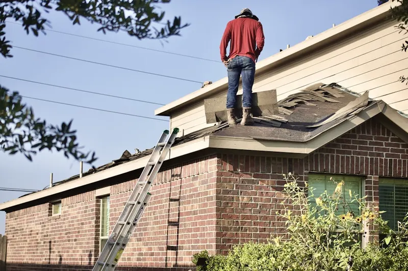 Professional roofer working on a residential roof in New Galena